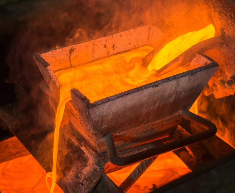 Casting gold at a factory. Gold mining.